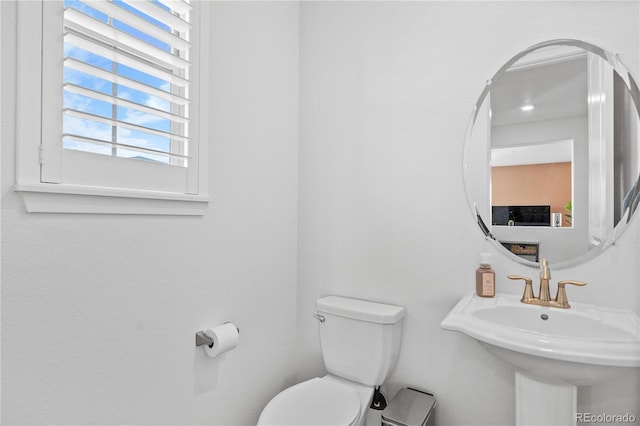 half bath with a sink and toilet