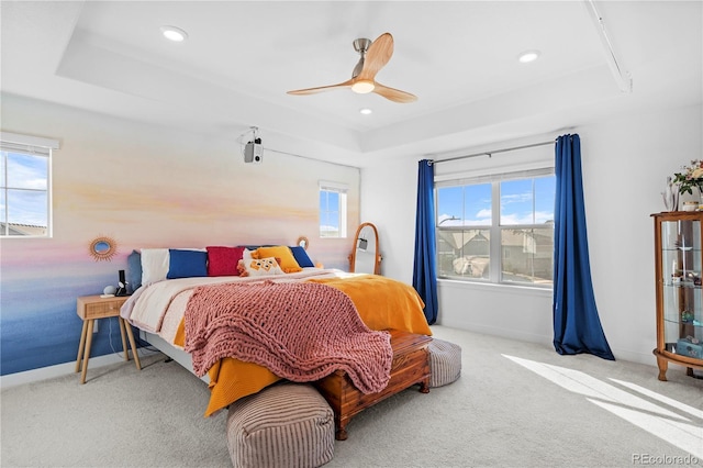 carpeted bedroom featuring baseboards, a ceiling fan, a tray ceiling, and recessed lighting