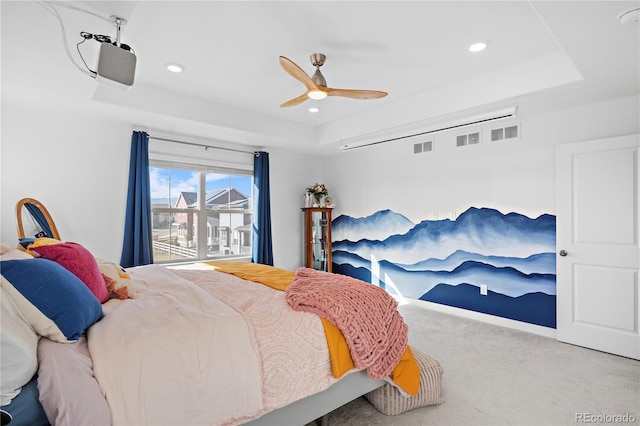 bedroom with carpet floors, recessed lighting, visible vents, and a raised ceiling