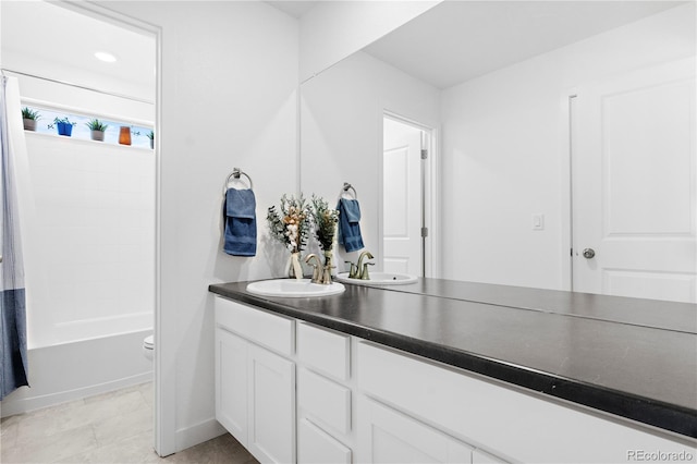 bathroom with toilet, shower / tub combo with curtain, and vanity