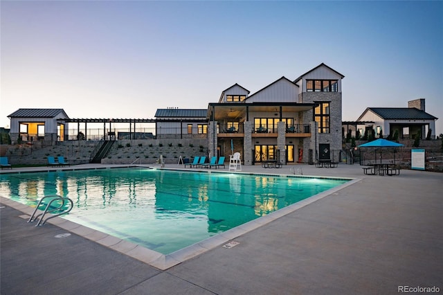 community pool with fence and a patio