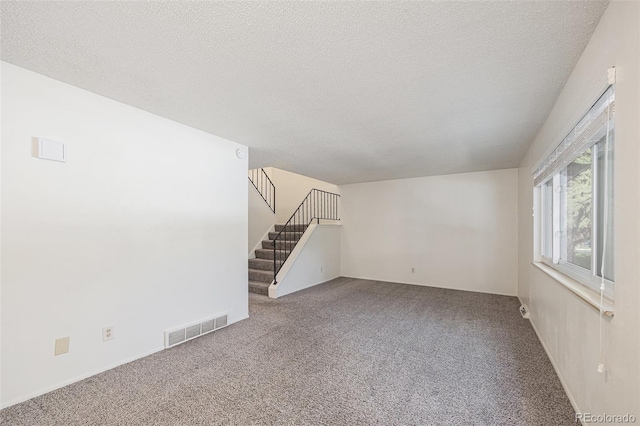 360 Upham St, Lakewood, CO 80226 - unfurnished living room featuring carpet flooring, stairway, and a textured ceiling