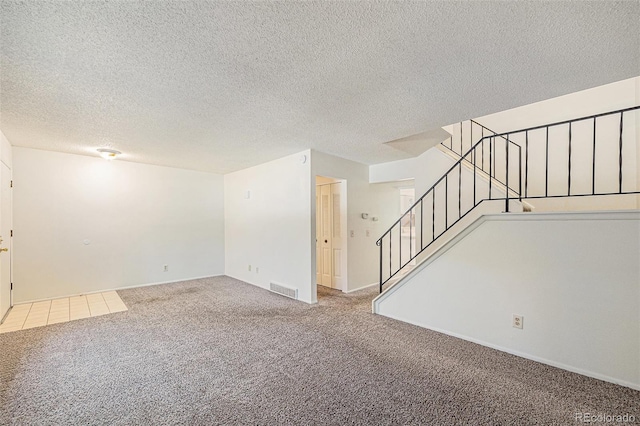 360 Upham St, Lakewood, CO 80226 - unfurnished room with carpet flooring, stairs, and a textured ceiling
