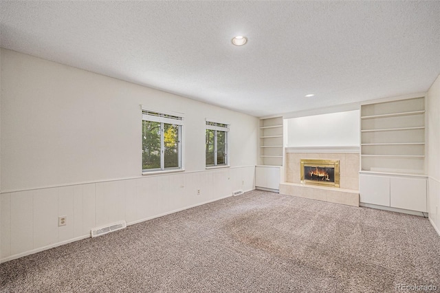 360 Upham St, Lakewood, CO 80226 - unfurnished living room featuring a textured ceiling, carpet flooring, a fireplace, recessed lighting, and built in features
