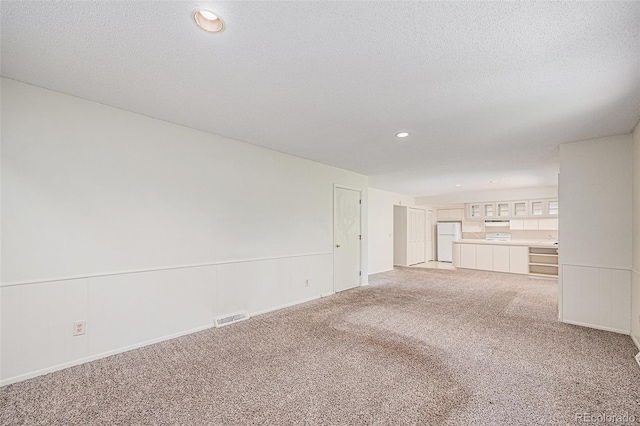 360 Upham St, Lakewood, CO 80226 - unfurnished living room with light carpet, recessed lighting, and a textured ceiling