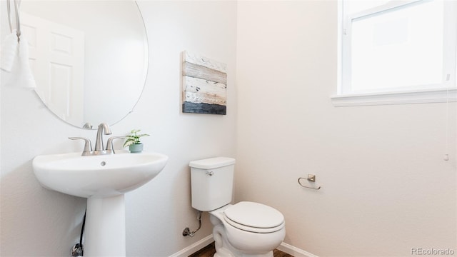 17850 W 94th Dr, Arvada, CO 80007 - half bathroom with toilet, baseboards, and a sink