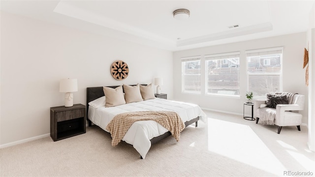 17850 W 94th Dr, Arvada, CO 80007 - bedroom featuring a tray ceiling, light colored carpet, and baseboards