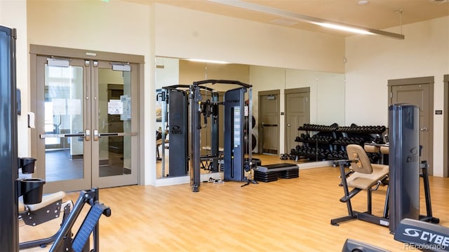 17850 W 94th Dr, Arvada, CO 80007 - exercise room with french doors, wood finished floors, and a towering ceiling