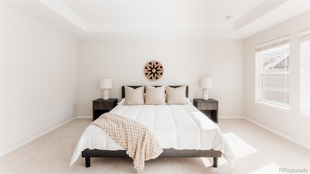 17850 W 94th Dr, Arvada, CO 80007 - bedroom featuring a tray ceiling, light carpet, ornamental molding, and baseboards