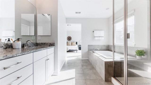 17850 W 94th Dr, Arvada, CO 80007 - full bath featuring vanity, connected bathroom, a bath, tile patterned flooring, and baseboards