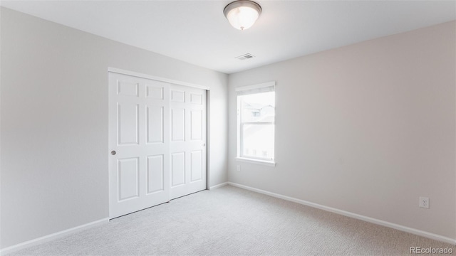 17850 W 94th Dr, Arvada, CO 80007 - unfurnished bedroom with light colored carpet, a closet, and baseboards