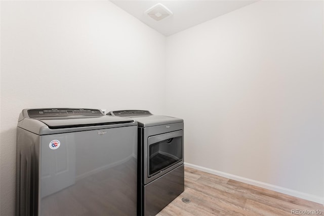 17850 W 94th Dr, Arvada, CO 80007 - washroom with independent washer and dryer, light wood-type flooring, and baseboards