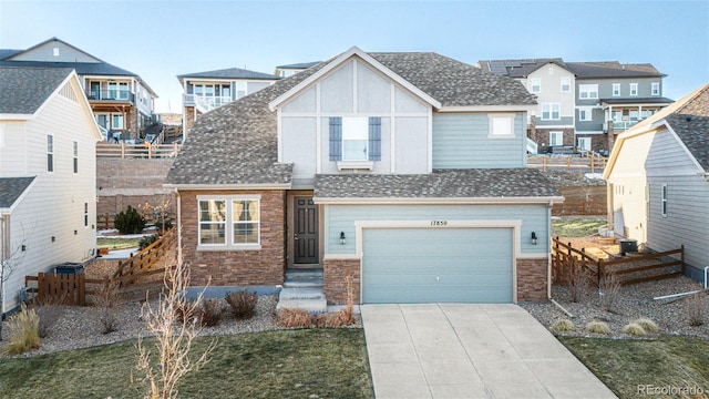 17850 W 94th Dr, Arvada, CO 80007 - view of front of home with concrete driveway, an attached garage, and stone siding