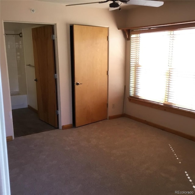 unfurnished bedroom featuring baseboards, multiple windows, ceiling fan, and carpet flooring