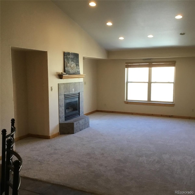 unfurnished living room featuring baseboards, carpet floors, high vaulted ceiling, recessed lighting, and a fireplace