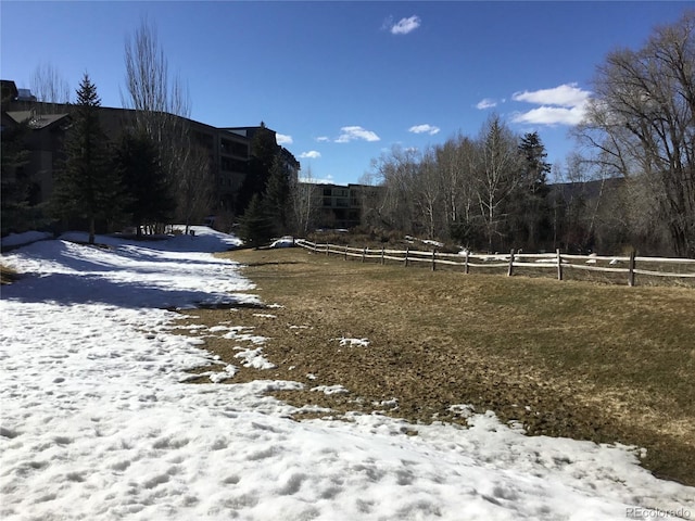 yard covered in snow with fence