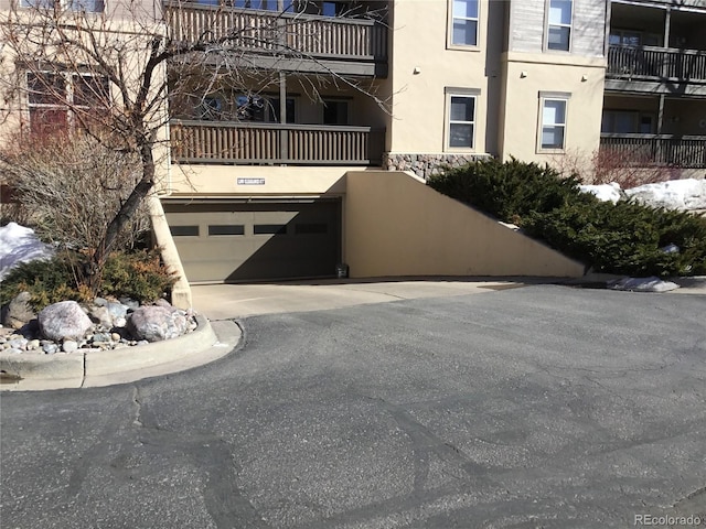 view of building exterior featuring a garage and driveway