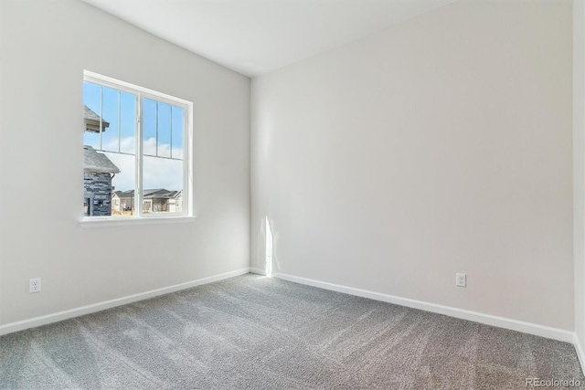 carpeted spare room with baseboards