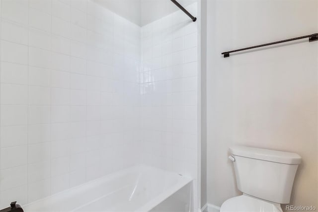 bathroom featuring toilet and bathing tub / shower combination