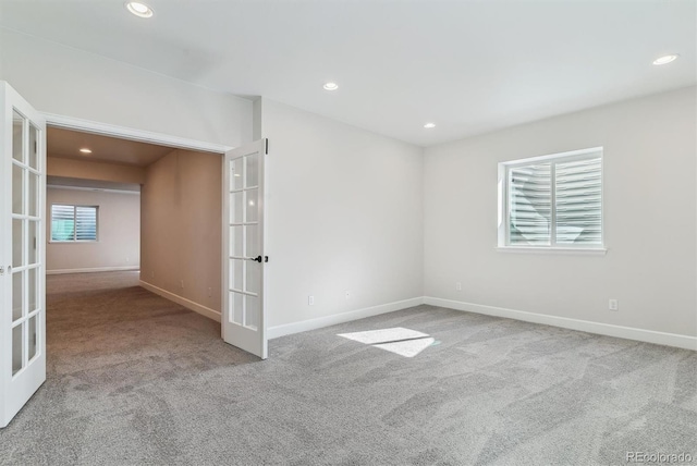 unfurnished room with carpet floors, recessed lighting, french doors, and baseboards