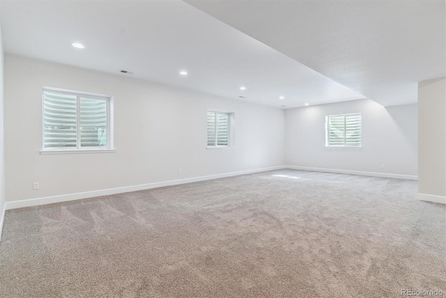 carpeted spare room with recessed lighting, visible vents, and baseboards