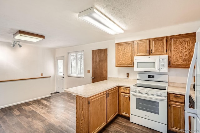kitchen with light countertops, a peninsula, brown cabinets, white appliances, and dark wood-type flooring