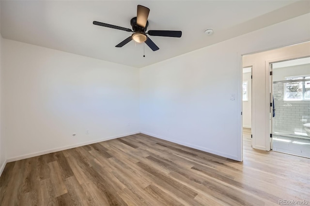 unfurnished room with ceiling fan, baseboards, and wood finished floors