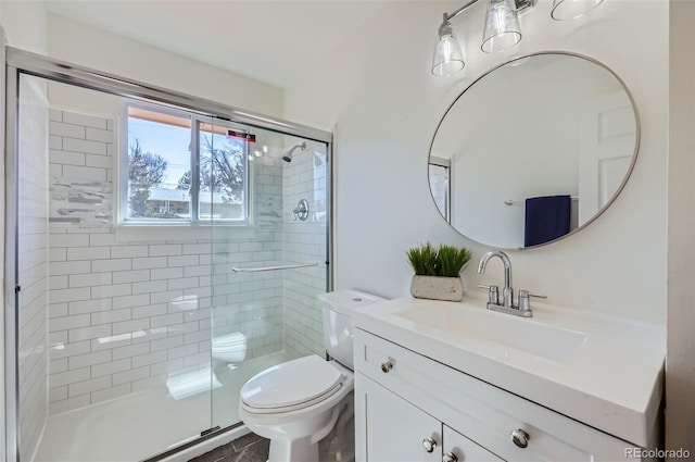 full bathroom featuring a stall shower, vanity, and toilet