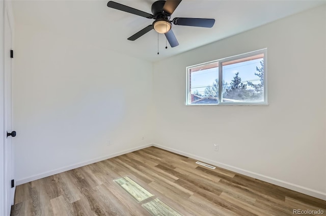 empty room with light wood-style floors, baseboards, and a ceiling fan