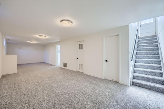 interior space with carpet, stairs, and visible vents