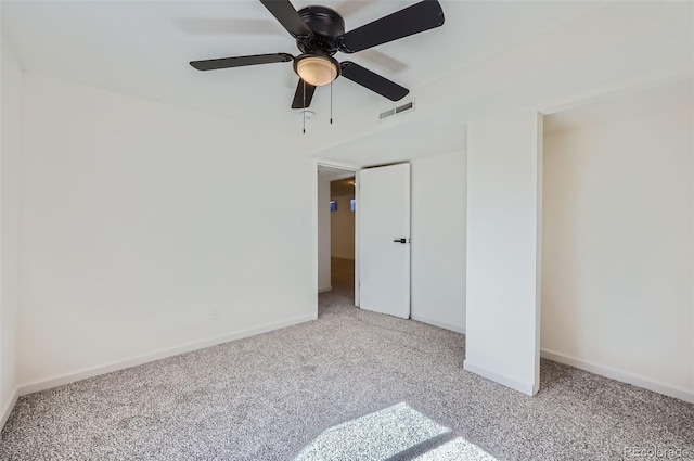 unfurnished bedroom with a ceiling fan, carpet, visible vents, and baseboards