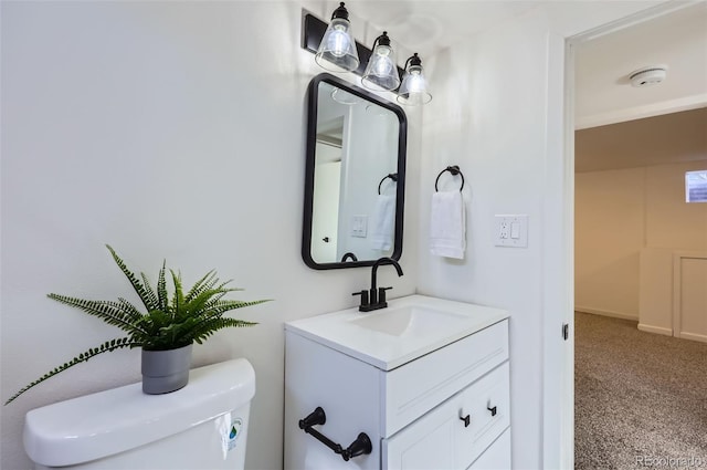 bathroom featuring toilet and vanity