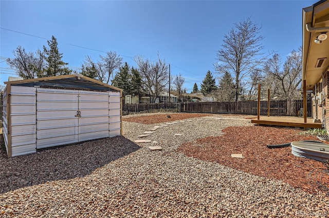 view of yard with a shed, an outdoor structure, and a fenced backyard