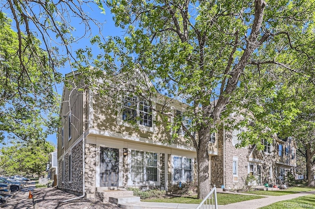 multi unit property featuring stone siding
