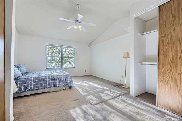 carpeted bedroom featuring lofted ceiling and ceiling fan
