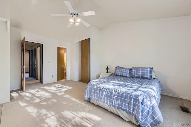 bedroom with carpet floors, vaulted ceiling, baseboards, and ceiling fan