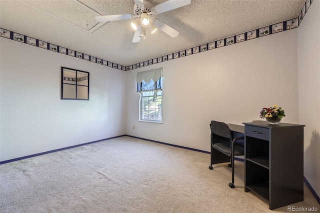 office space with a textured ceiling, carpet flooring, ceiling fan, and baseboards