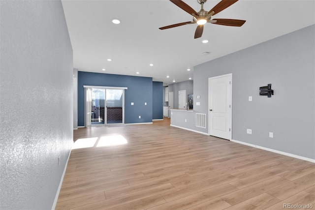 unfurnished living room with ceiling fan and light hardwood / wood-style flooring