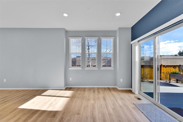 empty room with light hardwood / wood-style floors