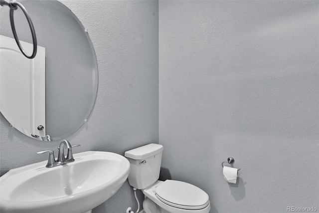 bathroom with toilet and sink