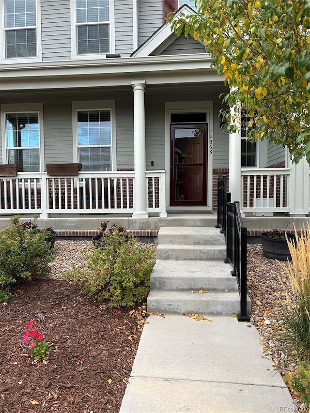 doorway to property featuring covered porch