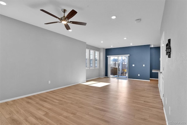 unfurnished living room with ceiling fan and light hardwood / wood-style floors