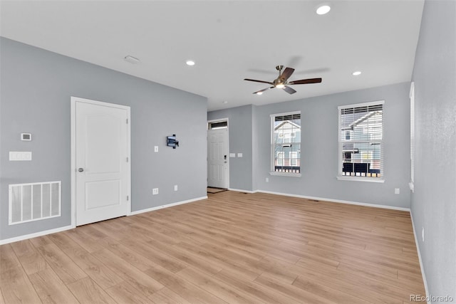 empty room featuring ceiling fan and light wood-type flooring