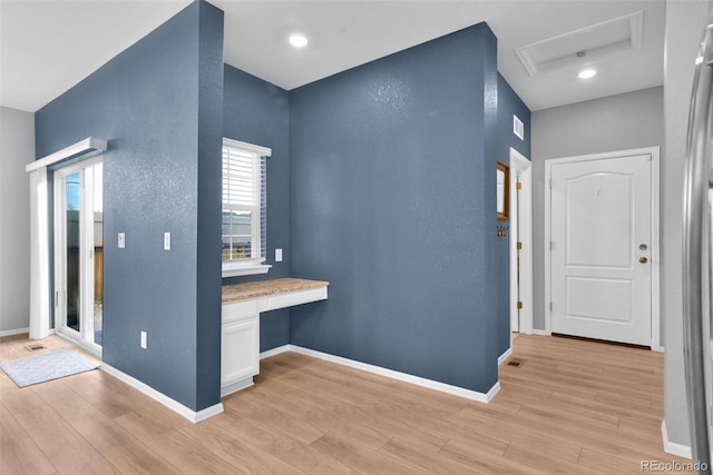 hallway with light hardwood / wood-style flooring