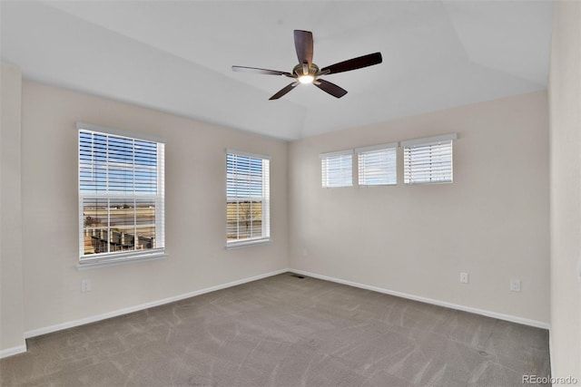 unfurnished room with ceiling fan, light carpet, and vaulted ceiling