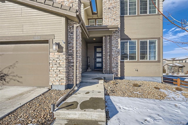 doorway to property with a garage