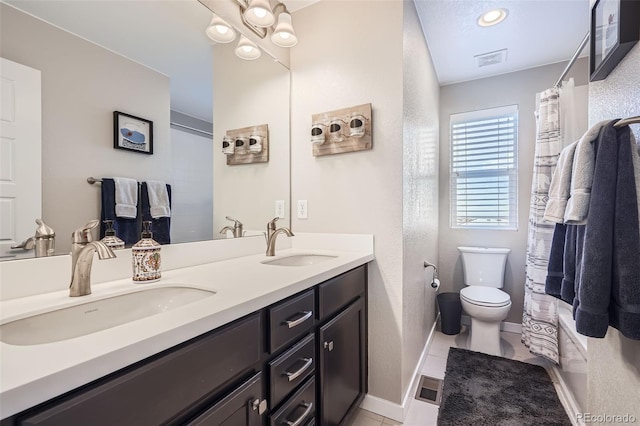 full bathroom featuring shower / bath combo with shower curtain, toilet, vanity, and tile patterned flooring