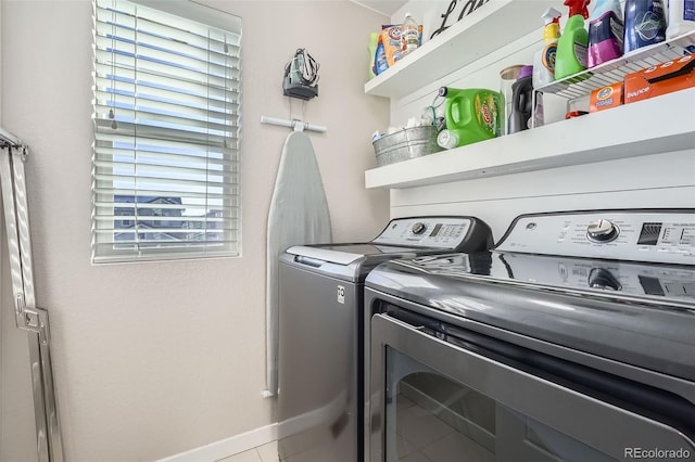 washroom featuring plenty of natural light, washing machine and dryer, and tile patterned flooring