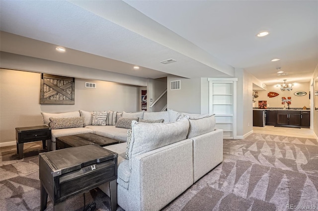 carpeted living room with a notable chandelier