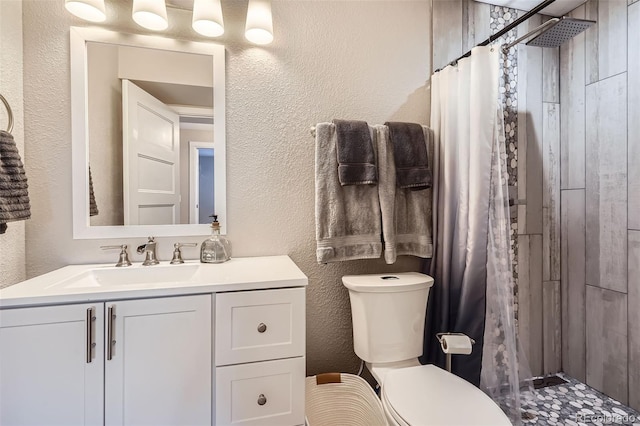 bathroom featuring vanity, toilet, and a shower with curtain